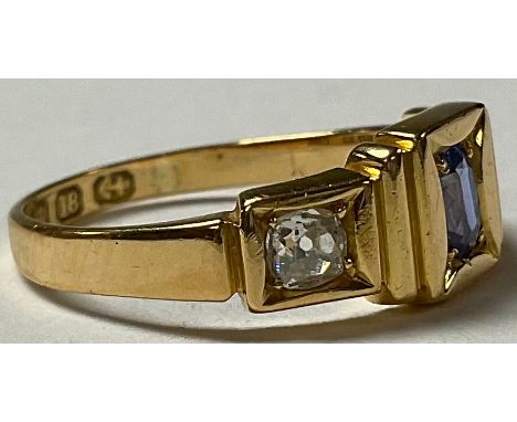 An 18ct gold three stone diamond and sapphire ring, size L/M, 3.5g 