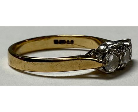 A 9ct gold three stone diamond ring, marked 375, size K, 2g 
