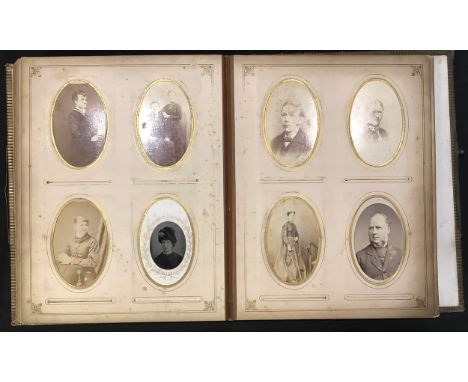 Photography - a 19th century leather bound carte de visite album, the cover painted with a floral spray, containing mostly po