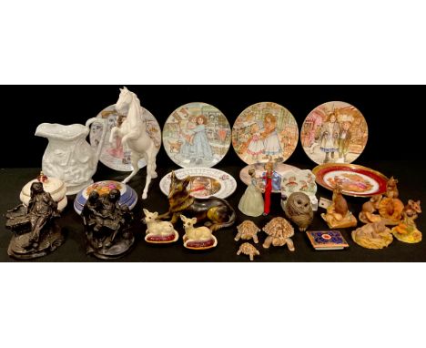 A Beswick biscuit glazed model of a rearing horse; a clockwork Cinderella and Prince Charming dancing model; two Beswick Chih