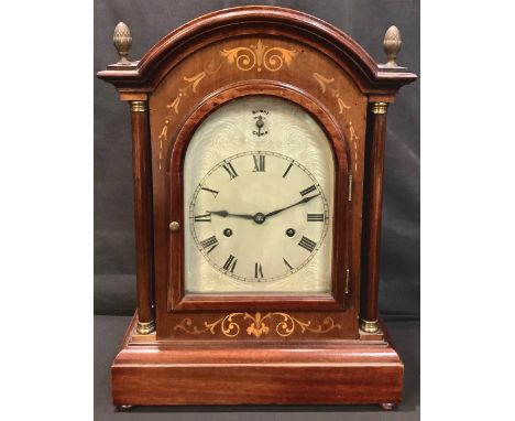 An early 20th century mahogany inlaid mantel clock, arched case, Roman numerals on silvered dial, twin winding holes, Westmin
