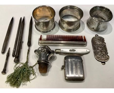 Three silver napkin rings; a silver vesta case, Birmingham; a mother of pearl fruit knife; a travelling comb; etc 