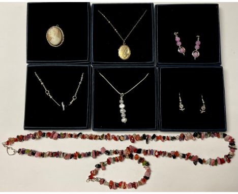 A 9ct gold plated locket with 9ct chain; a pair of sterling silver earrings with polished pink stones; a cameo brooch; a fres