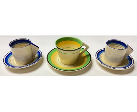 A Clarice Cliff coffee cup and saucer, angular handle, painted with bands of yellow, green and brown, printed Wilkinson mark 