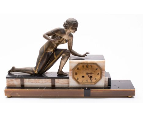 An Art Deco mantel clock mounted with a silvered spelter female figure (damaged).


