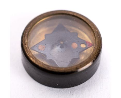 A WWII button compass. 


