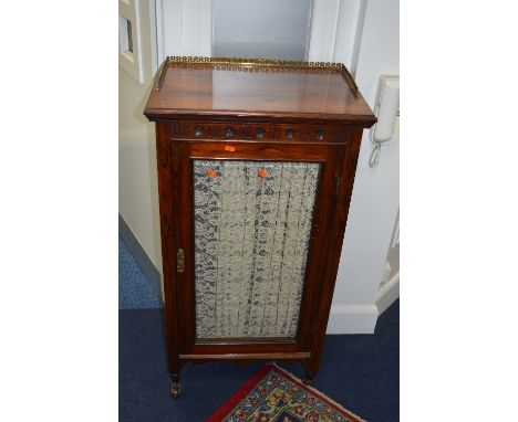 A VICTORIAN ROSEWOOD GLAZED SINGLE DOOR MUSIC CABINET, with brass gallery top, blue baize interior, on ceramic casters, appro