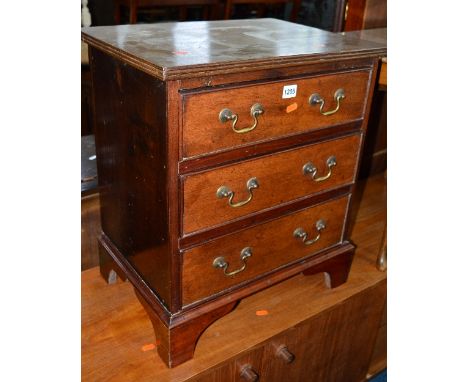 A SMALL GEORGIAN STYLE MAHOGANY CHEST OF THREE GRADUATED DRAWERS, with brass swan neck handles on bracket feet, approximate s