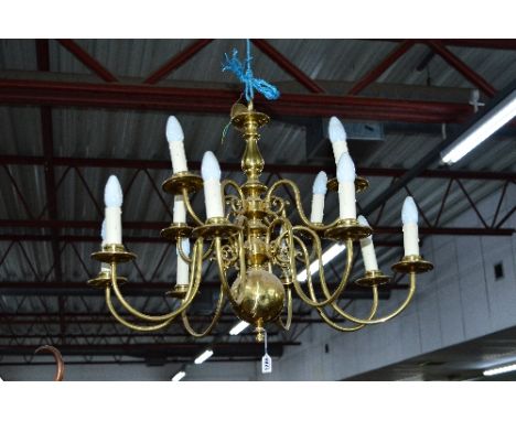 A 20TH CENTURY BRASS TWELVE BRANCH CHANDELIER, with two tiers and electrical wiring