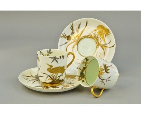 TWO ROYAL WORCESTER CUPS AND SAUCERS, gilt decorated with chinoiserie crane on cream ground (one saucer with crack/hairline, 