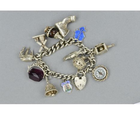 A SILVER CHARM BRACELET, with various charms, approximate weight 81.7 grams