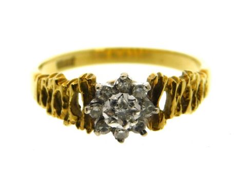 An 18ct gold diamond ring set with illusion set centre stone within eight small diamonds, 3.4g, size N/O