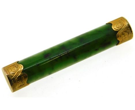 An antique jade bar brooch set with yellow metal ends, electronically test as 12ct gold, 54mm wide, 5.9g with a Burn &amp; Pe