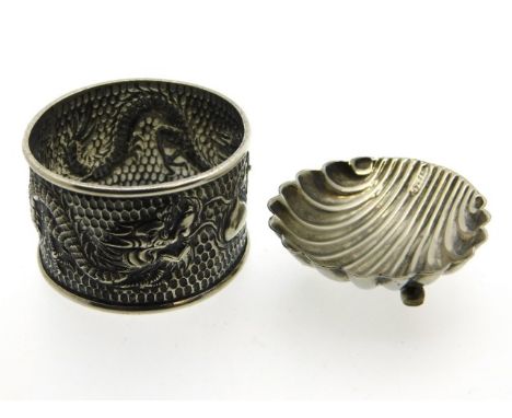 A white metal Oriental dragon napkin ring, tests as silver 25.2g, twinned with a silver plated shell shaped caviar dish