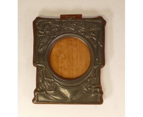 Art Nouveau pewter picture frame on wooden surround. Height 20cm 