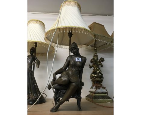 A lamp in the form of a plaster Art Deco style maiden, together with shade