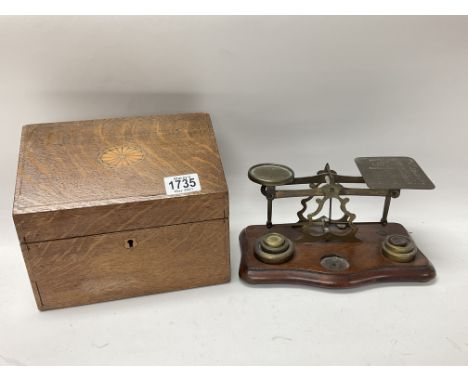 An oak inlaid Edwardian stationary box together with a set of brass postal scales.