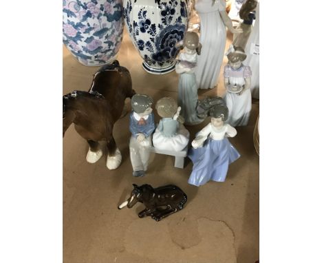 A collection of ceramics including two Lladro figures two Nao figures and Beswick horses .