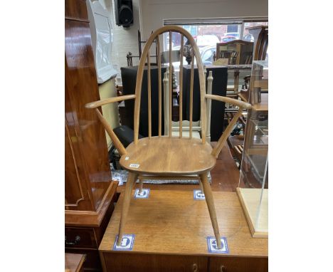 An Ercol beech stick back armchair.