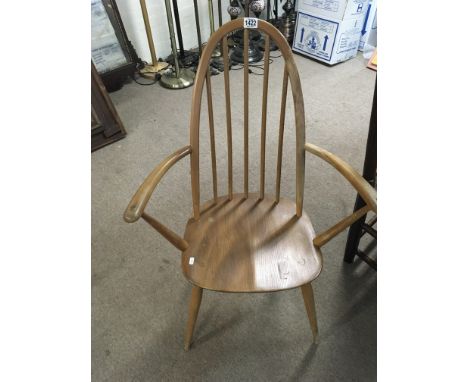 An Ercol light elm and beech open arm chair for restoration.
