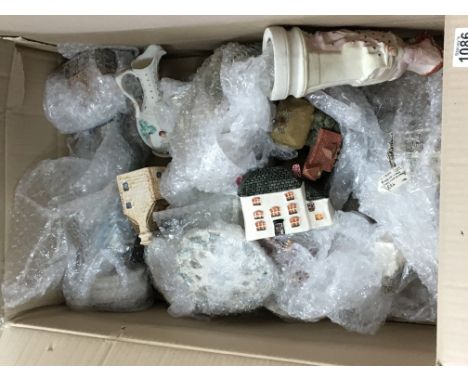 A box containing ceramic model cottages and other ceramic figures (a lot)