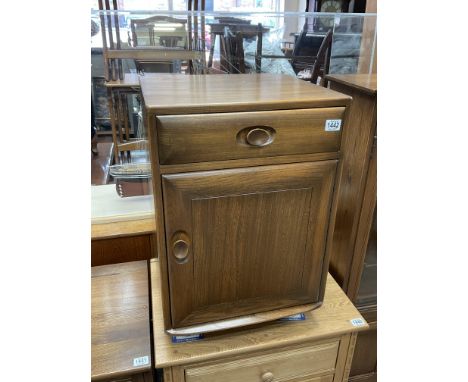 An Ercol bedside cabinet. Later casters added.