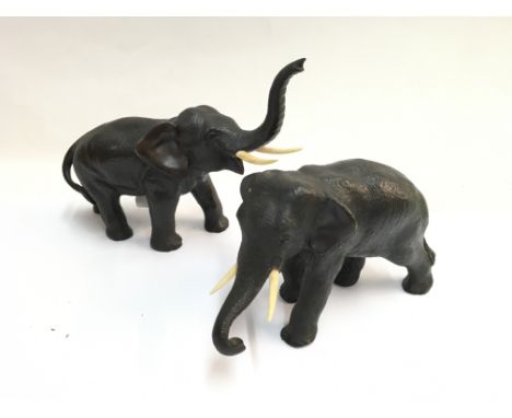 A pair of Japanese bronze elephant figures with ivory tusks. H.10cm.