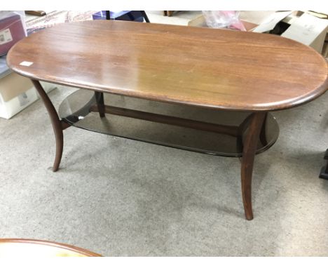 A modern Ercol oval coffee table with a glass under shelf. Length 115cm and a Canterbury magazine rack. (2)