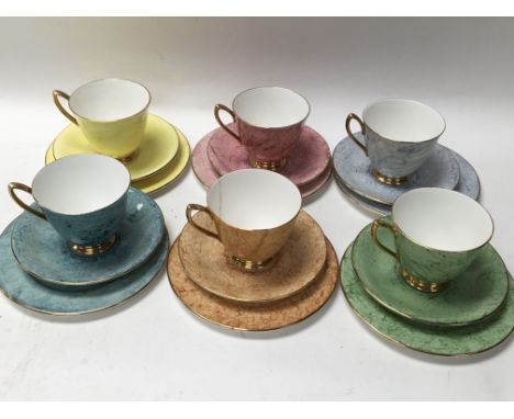 A Royal Albert multicoloured marbled effect Harlequin tea set with 6 cups, 6 saucers and 6 side plates. One damaged cup as pi