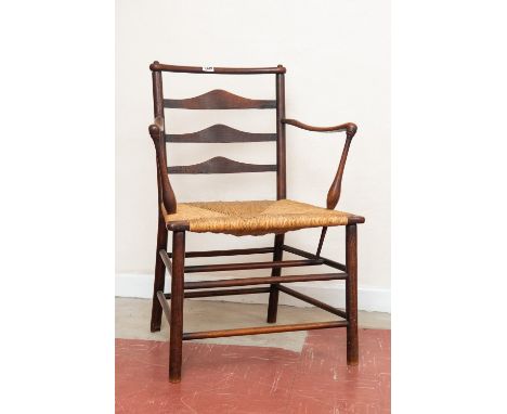 An Early 19th century ladder back open arm chair.