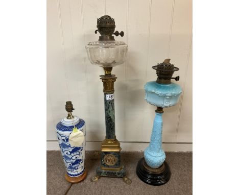 A large gilt bronze and marble coloumn oil lamp, A Victorian blue milk glass oil lamp and a late Chinese design porcelain lam