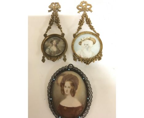 Two early 20th century gilt framed miniatures portraits of young ladies the frames with extended hanging simulated garlands a