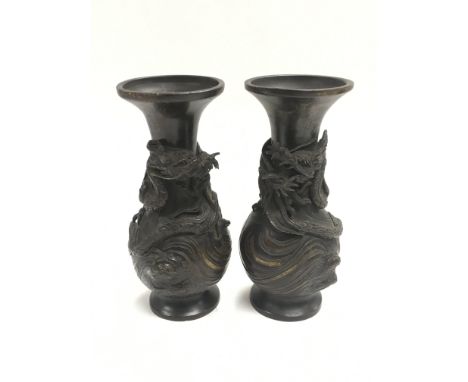 A pair of Oriental parcel gilt bronze vases decorated with applied dragons, approx 15.5cm.