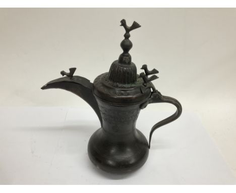 Interesting old possibly Islamic lidded jug with four cockerels. Bronze or bronzed.