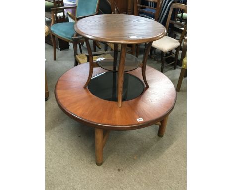 An Ercol occasional table with a circular top above a glass shelf and one other modern design coffee table of circular shape 