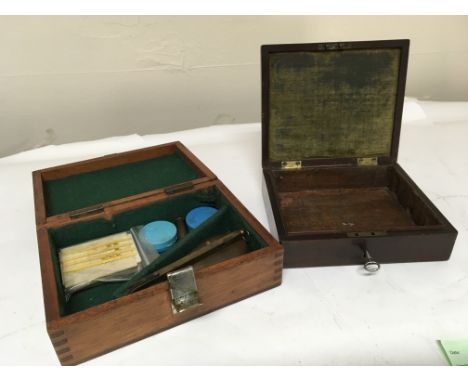 An antique pistol mahogany box lacking interior and one other box with a small powder flask and other oddments. (2)