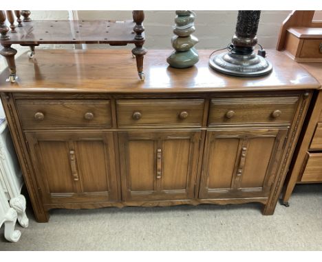 A low ercol sideboard. 142 x 51 x 85cm