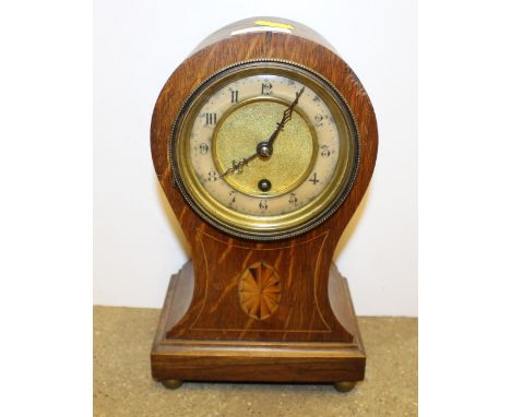 An Edwardian oak and inlaid single hole balloon mantel clock