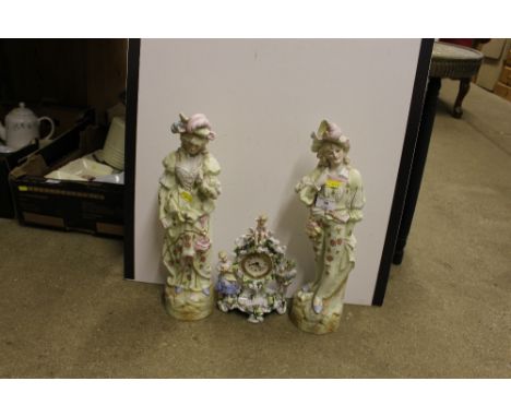 A china cased mantel clock and a pair of large ornaments