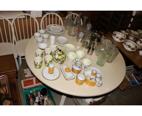 A painted circular topped kitchen table; and a set of four stick back chairs 