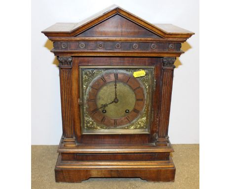 A late 19th Century walnut cased two hole mantel clock of architectural form