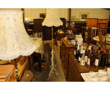 A wrought iron standard lamp and shade 