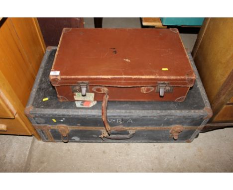 A travelling trunk; and a brown leather suitcase 
