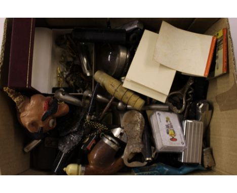 A box containing various corkscrews; a pipe; costume jewellery; a set of pocket balance scales etc.