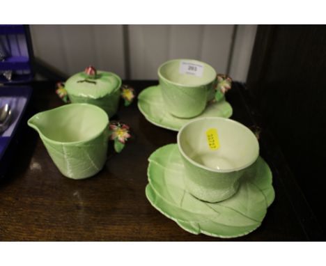 Two Carlton ware leaf tea cups and saucers with matching cream jug and sugar bowl  