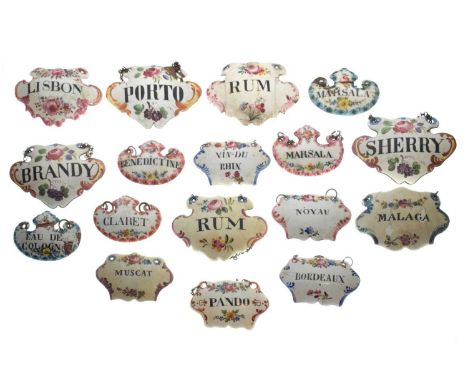 Collection of seventeen mid 18th century and later enamel wine and spirit decanter labels, of cartouche and escutcheon form d