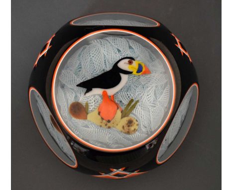 John Deacons black and orange window cut paperweight having a light blue and white latticinio interior with a Puffin atop of 