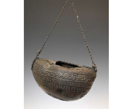 19th century Coco-de-mer begging bowl (Kashkul), engraved with Arabic calligraphic register over foliate banding and figural 