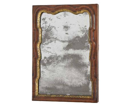 Early 18th century walnut and parcel gilt rectangular wall mirror, the shaped Vauxhall-type bevelled plate within a gilt-gess