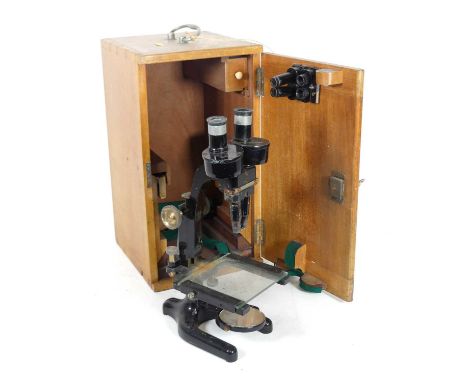 A mid-20th century Charles Perry binocular microscope, having an adjustable stage above a Y-shaped foot, h.36cm, in fitted wo